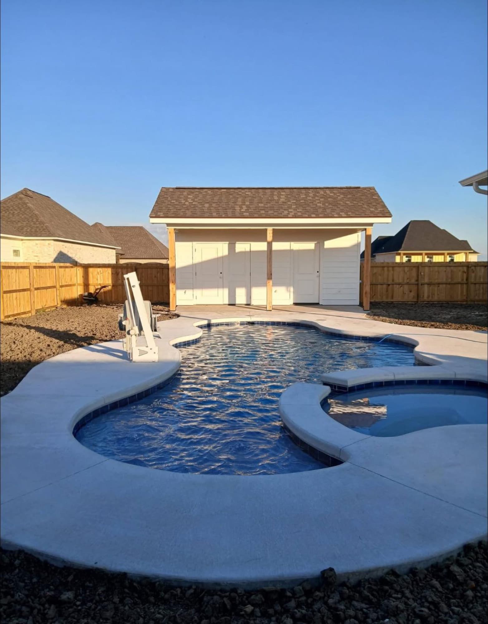 Completed pool house and pool with custom concrete decking — Lafourche Parish