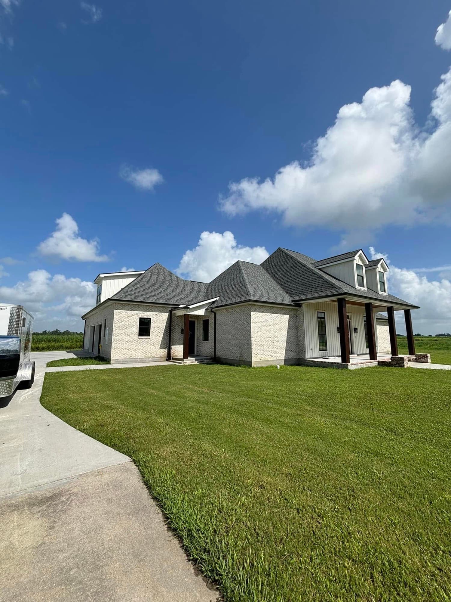 New home construction with modern white brick exterior in Raceland, LA by Foret Construction