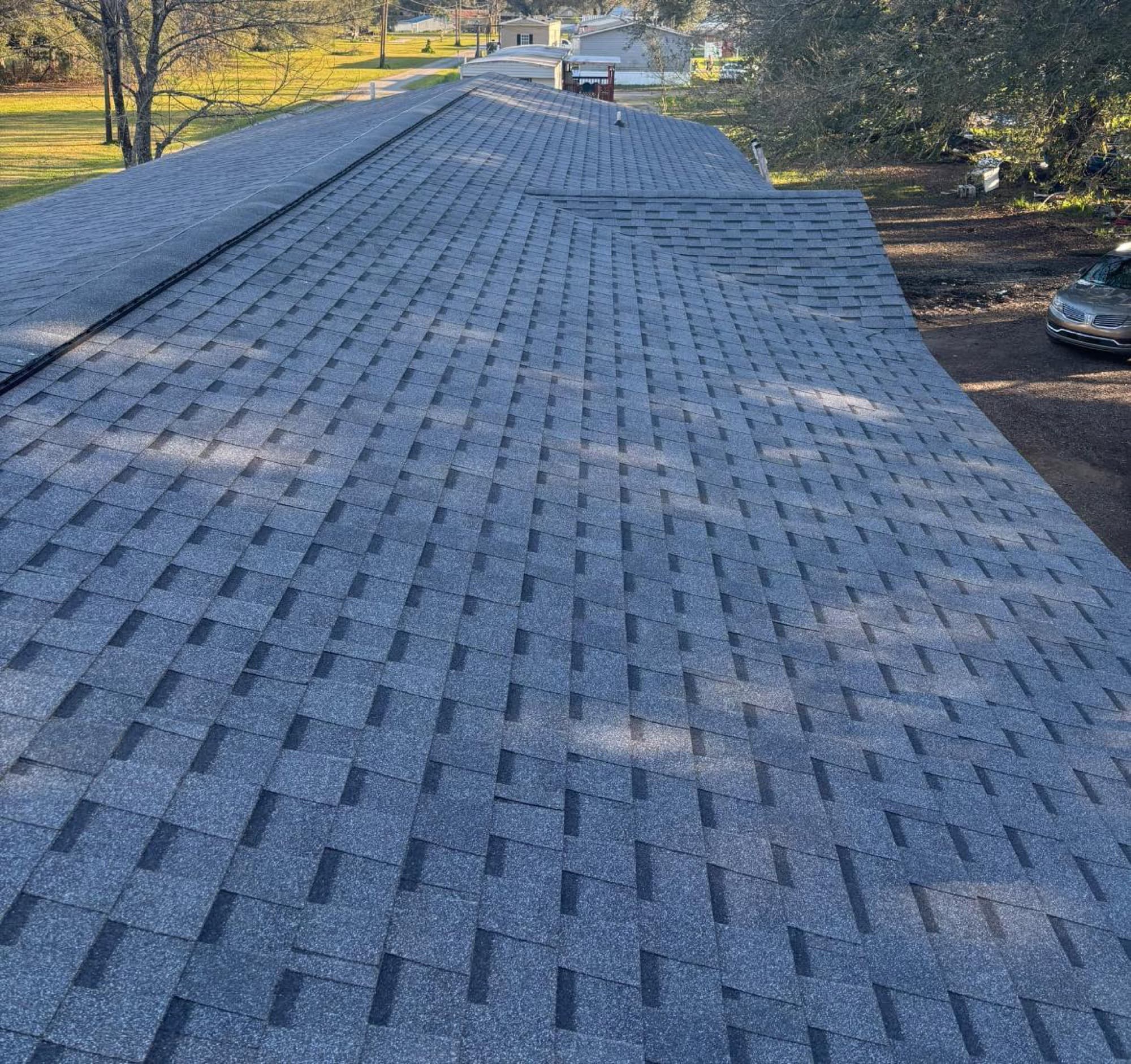 Aerial view of new asphalt shingle roof installed by Foret Construction in Raceland, LA